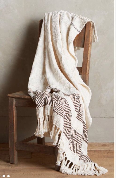 Cozy throw blanket styled in a comfortable bedroom